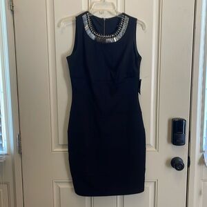 Black sheath dress with decorative neckline